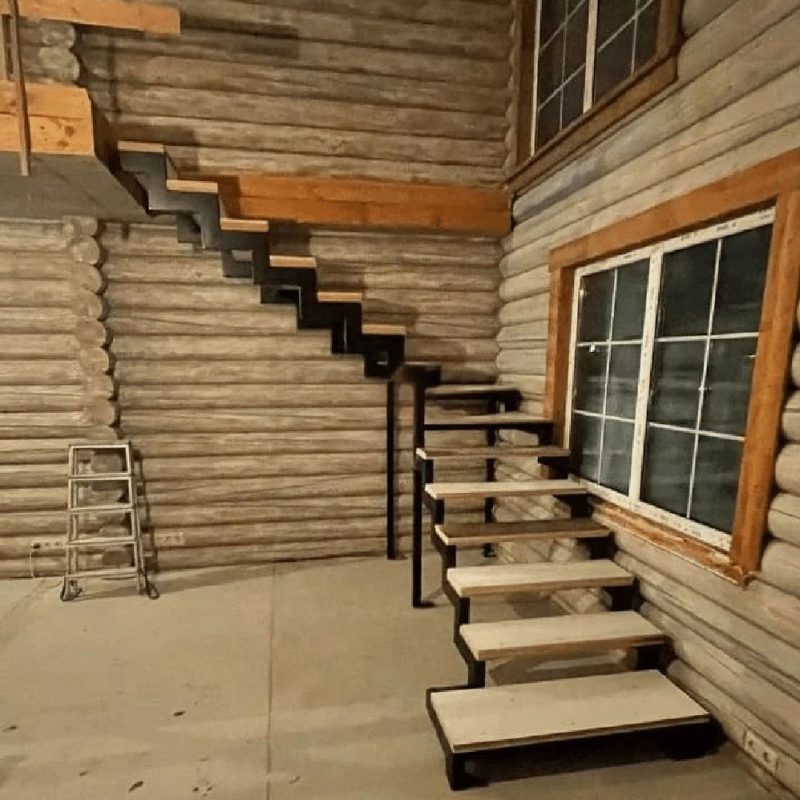 Г-образный металлокаркас лестницы на двух косоурах в брусовом доме с пригласительной